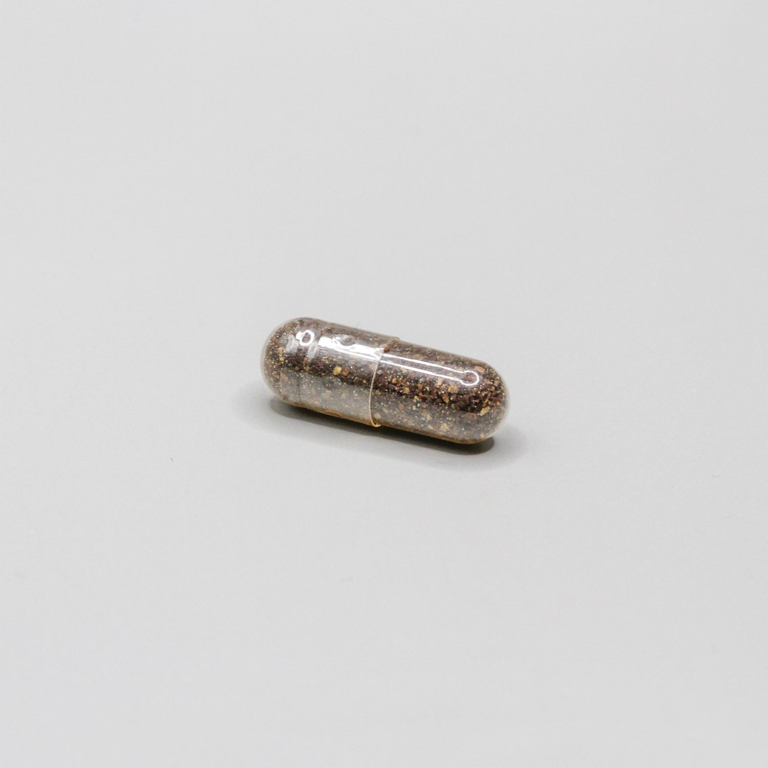 Pill filled with small brown pieces
