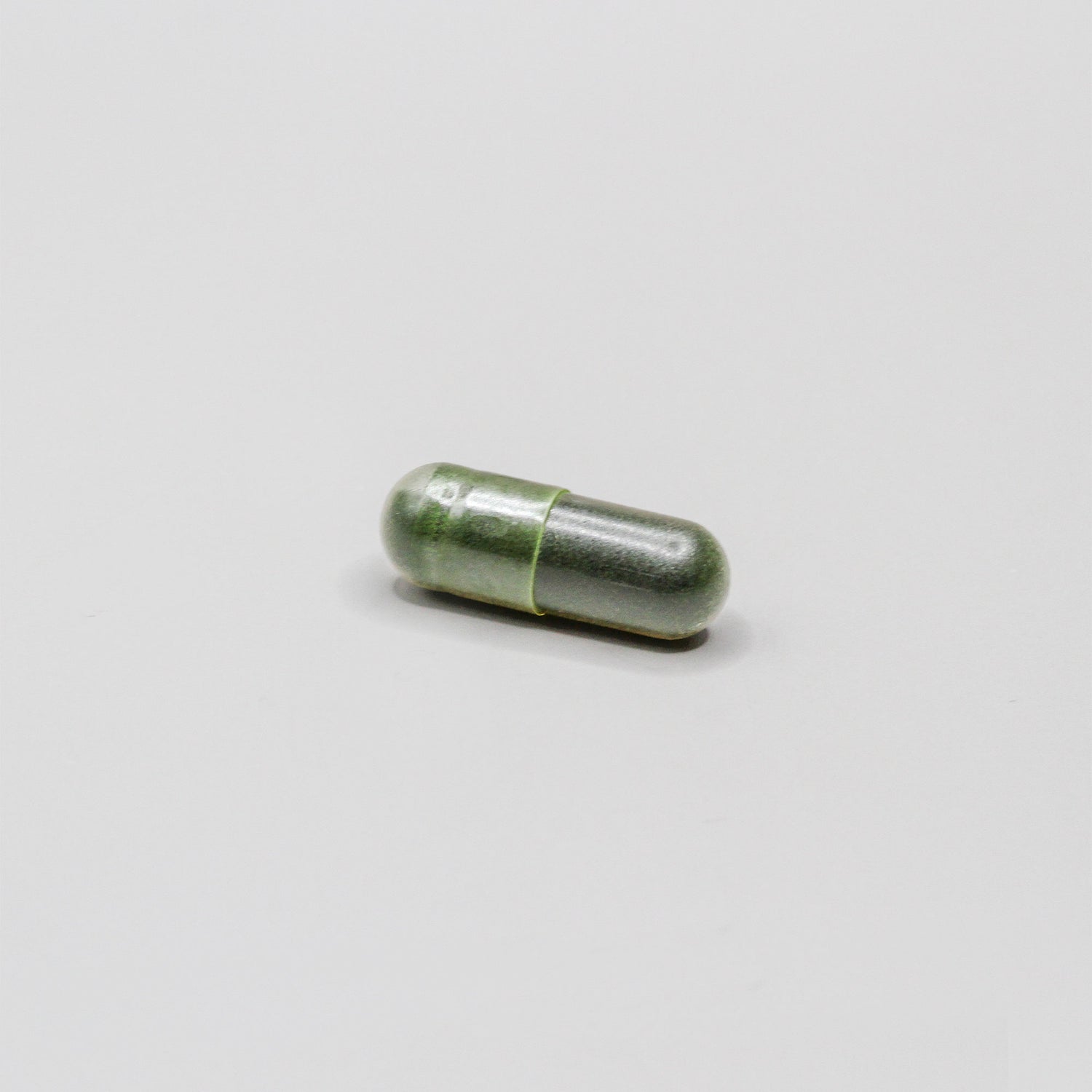 Dark green pill