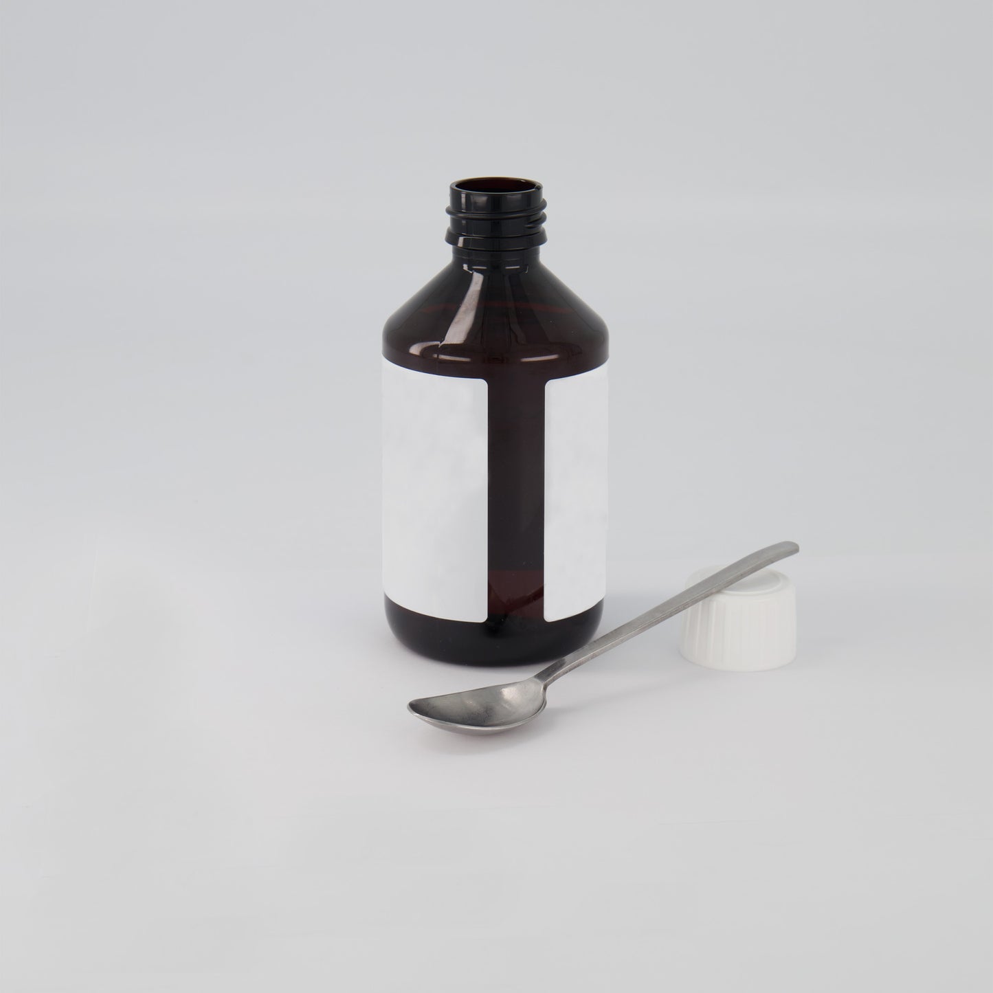 A bottle with a spoon